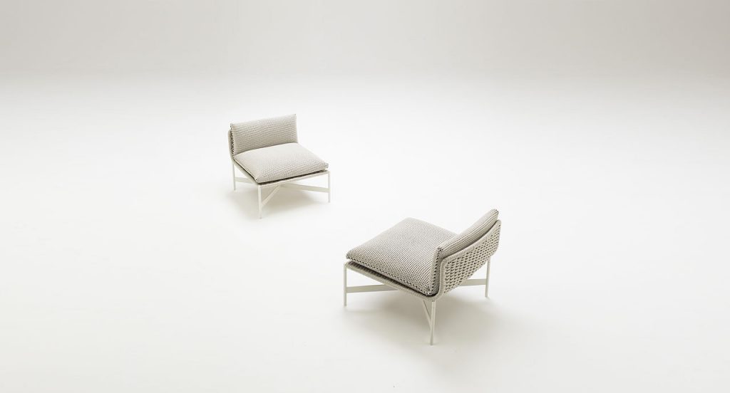 Two white Heron Stools, structure and four legs in steel, upholstery in rope cord, cushion in grey on a white background.