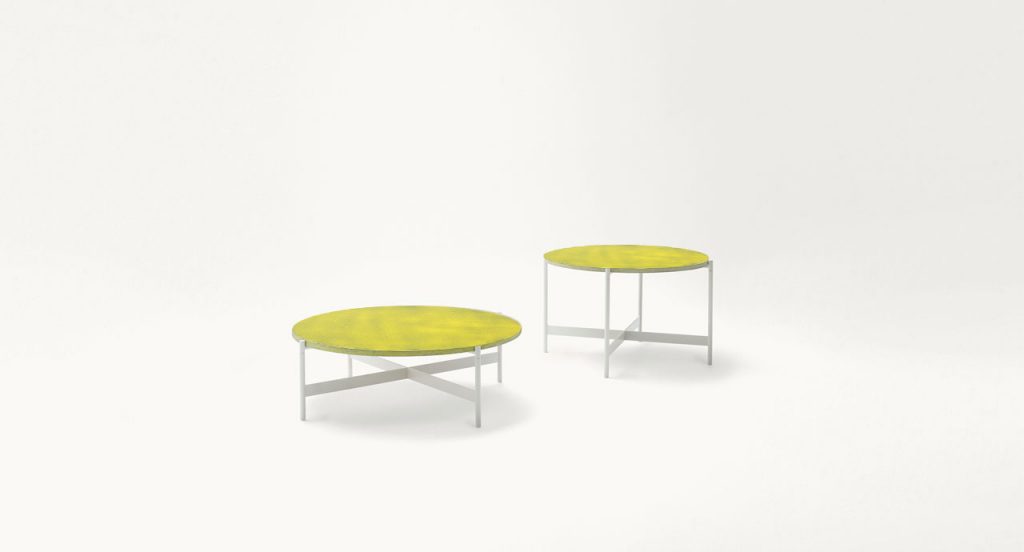 Two Heron Cofee Tables, structure and four legs in white steel, round top in yellow on a white background.