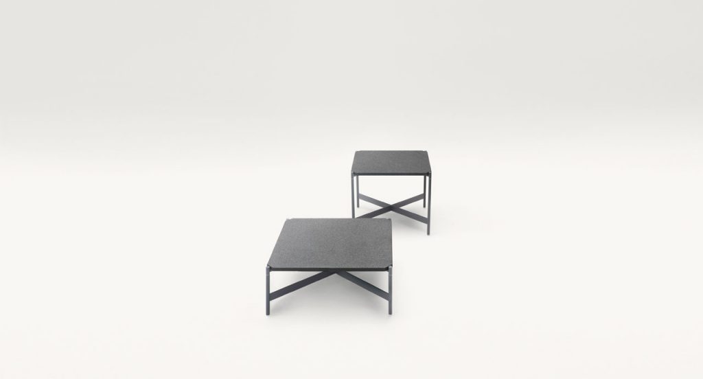 Two Heron Cofee Tables, structure and four legs in black steel, square top in black on a white background.