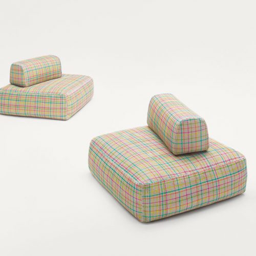 Two Hopi poufs, upholstery in blue, pink, orange and yellow lines pattern on a white background.