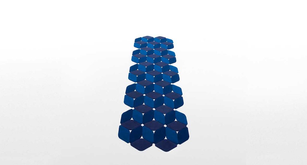 Kaleidoscope rug made of blue felt modules on a white background.