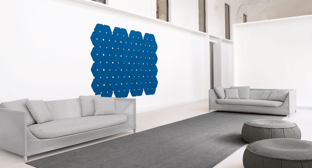 Kaleidoscope rug made of blue felt modules on a living room.