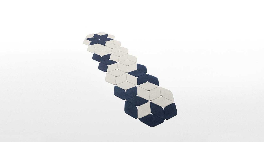 Kaleidoscope rug made of blue and white felt modules on a white background.