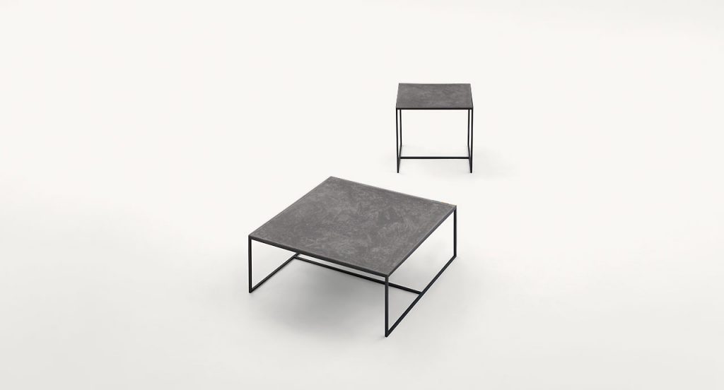 Two Lio side tables, leg structure steel, top in grey on a white background.