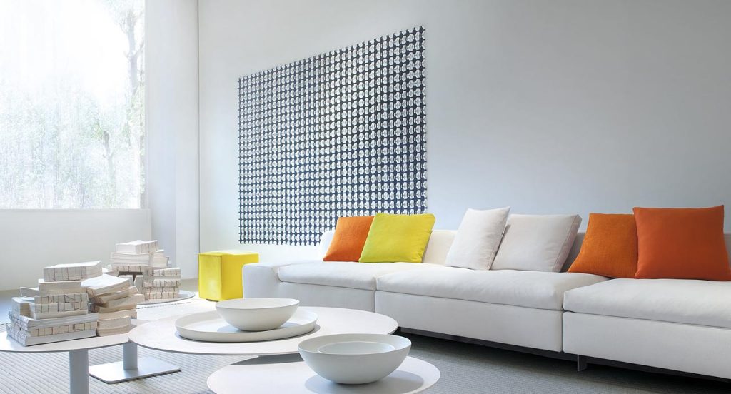 Loom rug made of white plastic rings and blue rope braids in a living room.