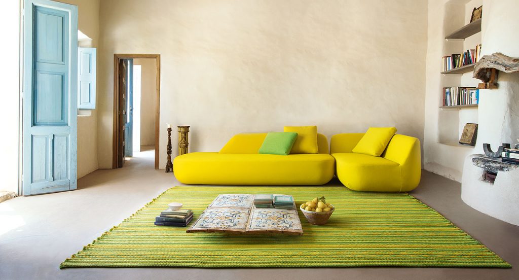 Navajo rug made of green and yellow rope braids in a living room.