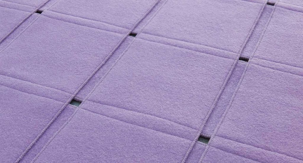 Purple Net rug made of parallel strips felt.