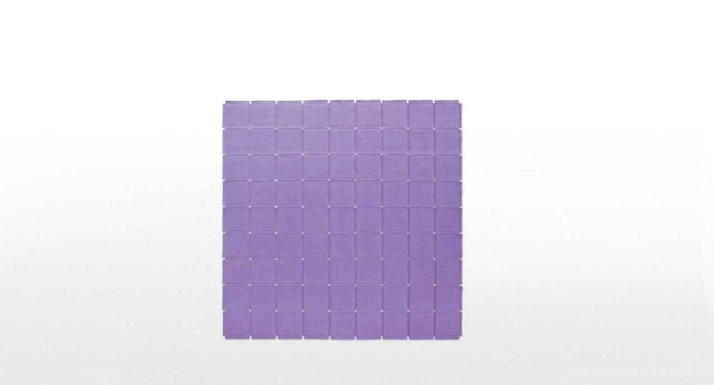 Purple Net rug made of parallel strips felt on a white background.