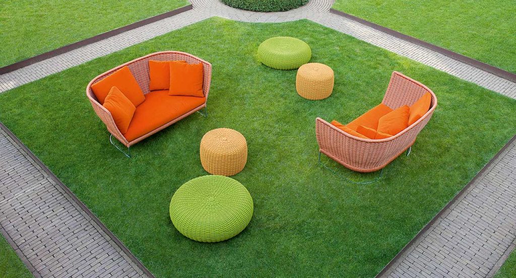 Two Nido Poufs, upholstery of yellow rope cord in a garden.