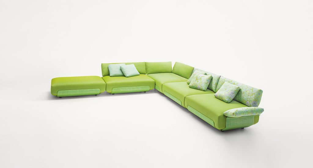 Four green Oasi, Series of single seatings, two with backrest and one of them with armrest in green and pink garden like patttern on a white background.