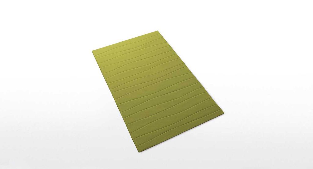 Onda rug made of felt in onda like pattern on a white background.