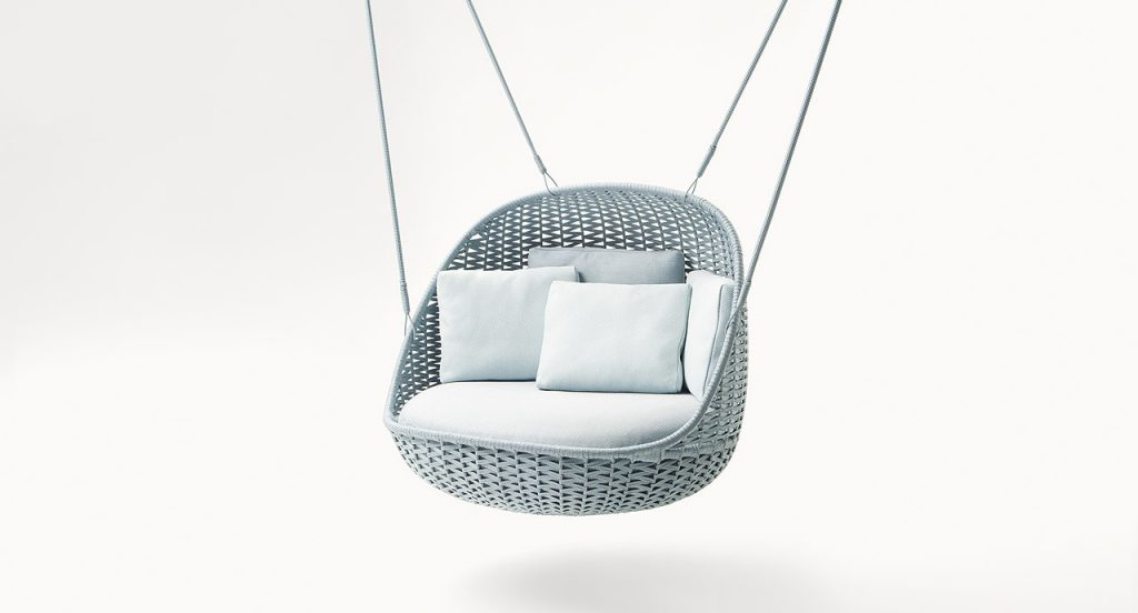 Blue suspended Orbitry Swing seat, structural weave in flad braids with cushions on a white background.