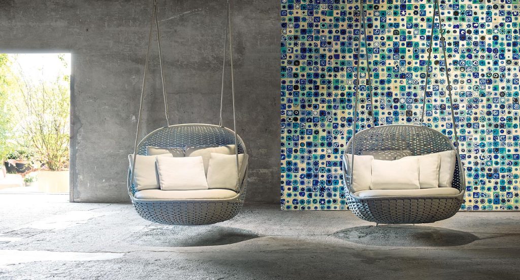 Two blue suspended Orbitry Swing seat, structural weave in flad braids with cushions in a living room.