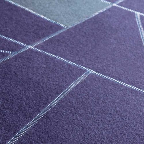 Origami rug made of felt, squares and diagonal stitching in purple and grey colors.