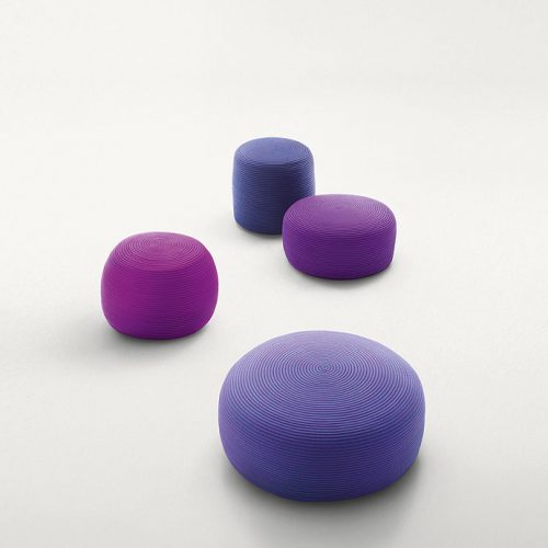 Four round Otto Pouf, upholstery in purple rope cord on a white background.