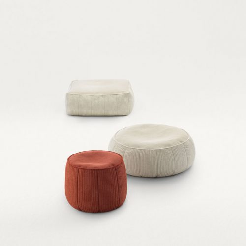 Three Play poufs, two in white and one in red fabric upholstery. Two in round and one in square shape on a white background.