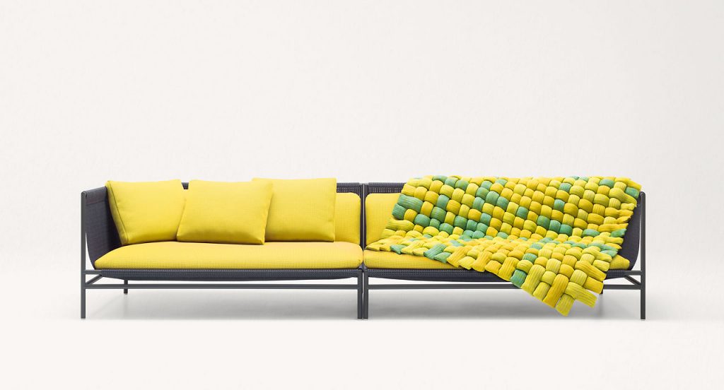 Plump pad Chain Outodoor tubular knit, padding in yellow and green polyester fiber on a sofa on a white background.