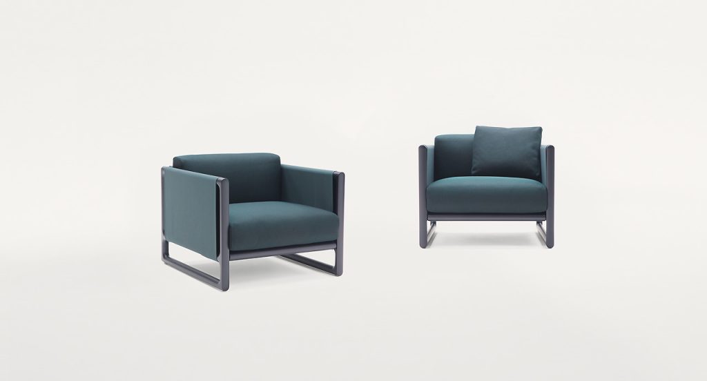 Two Portofino Outdoor Armchairs, structure in black steel, cushions in blue polyester on a white background.