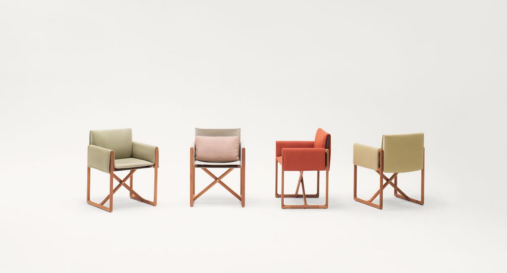 Four Portofino Outdoor Chairs with armrests and little armchair, structure and chair in natural heartwood, upholstered three in beige and one in orange fabric on a white background.