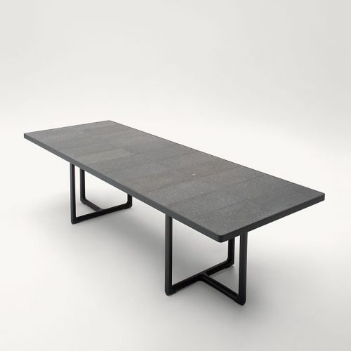 Large Portofino Outdoor Dining Table, two legs in dark heartwood, top in natural lava stone on a white background.