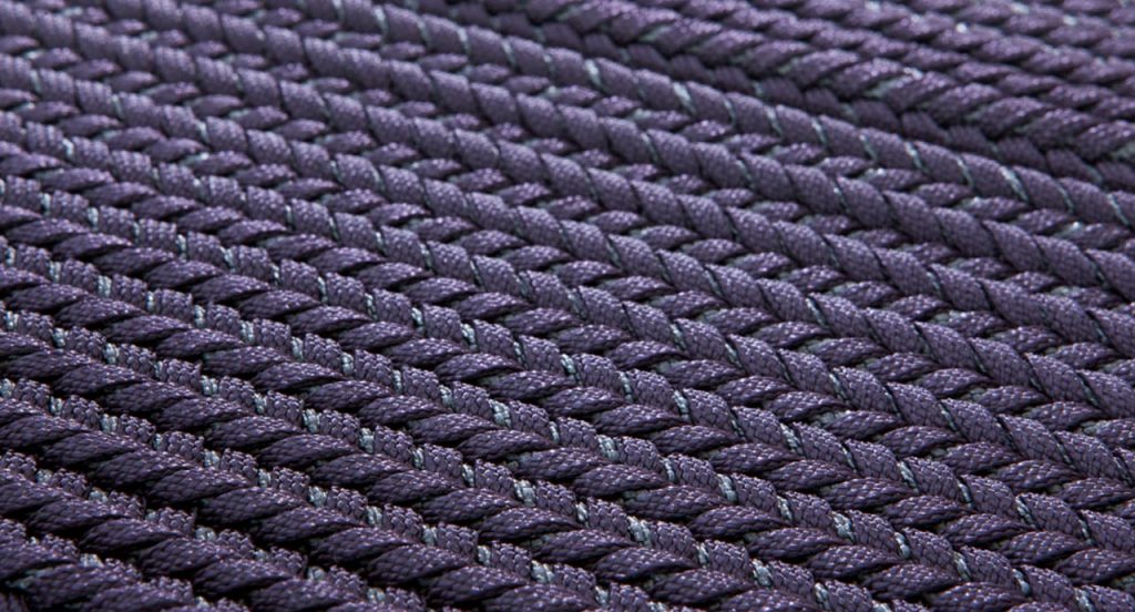 Ray rug made with purple wide braids.