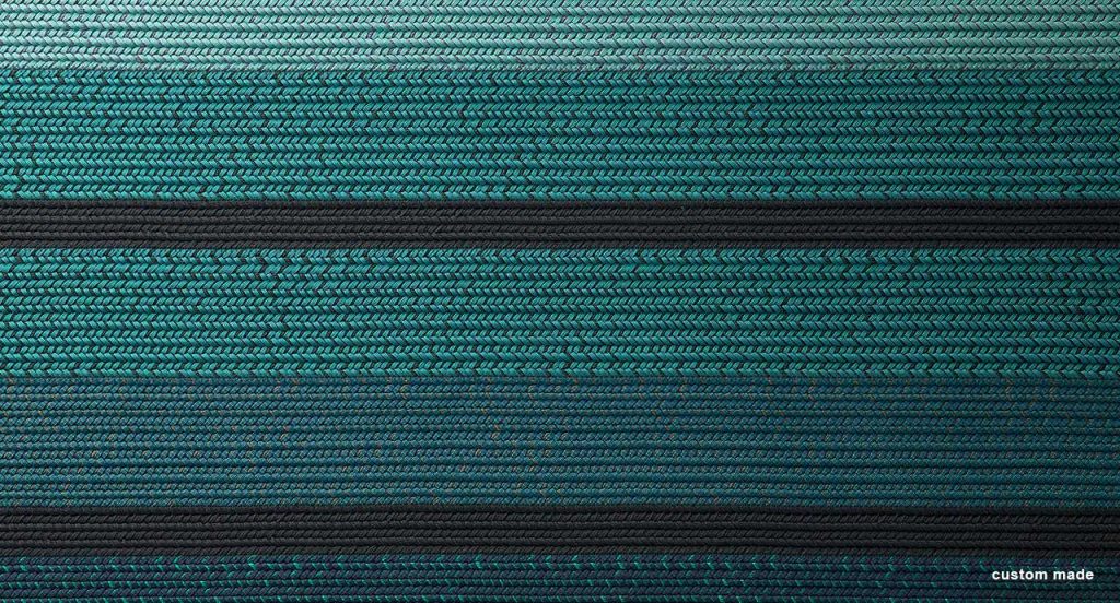 Ray rug made with blue and black wide braids.