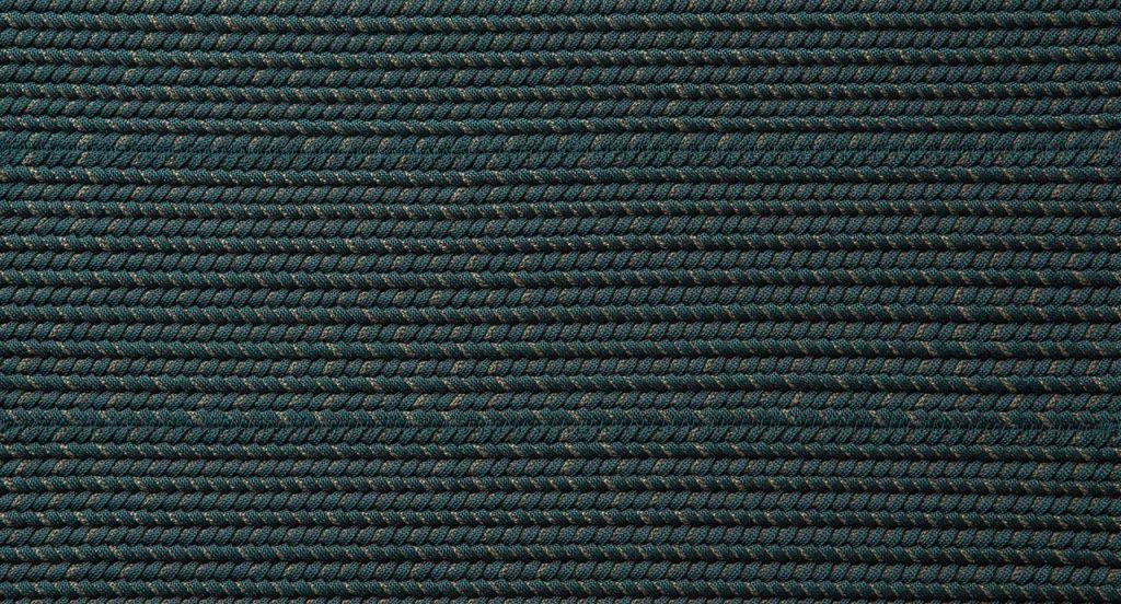 Ray rug made with black and brown wide braids.