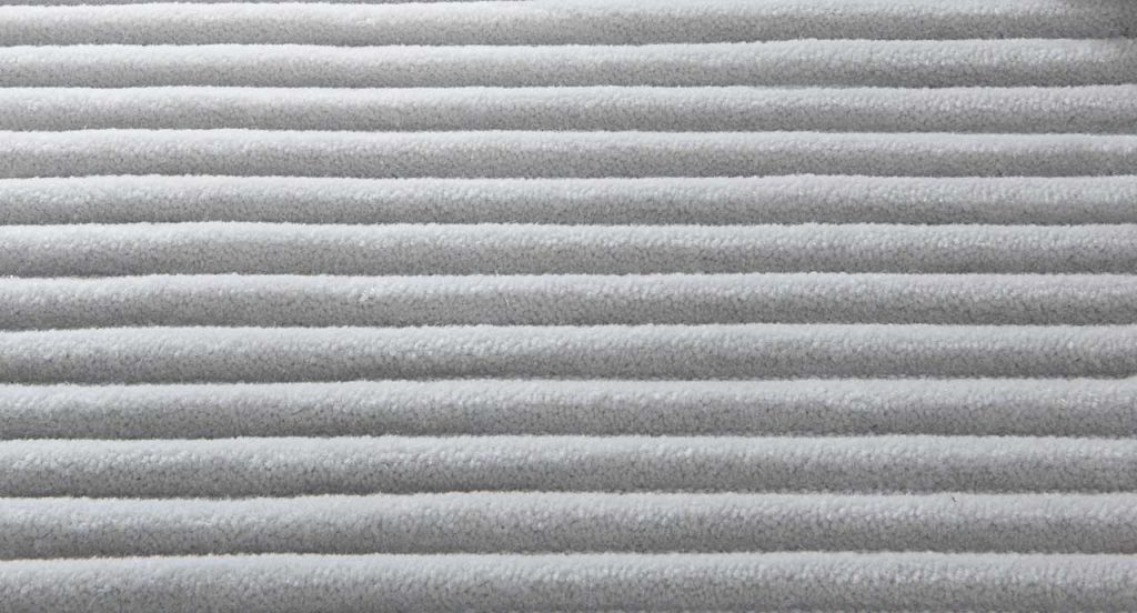 Grey Raya rug with parallel lines in relief.