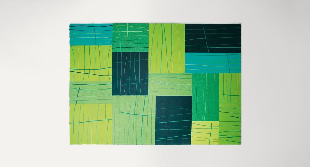 Blue and green Rilievo rug in wool cords and lines like pattern on a white background.