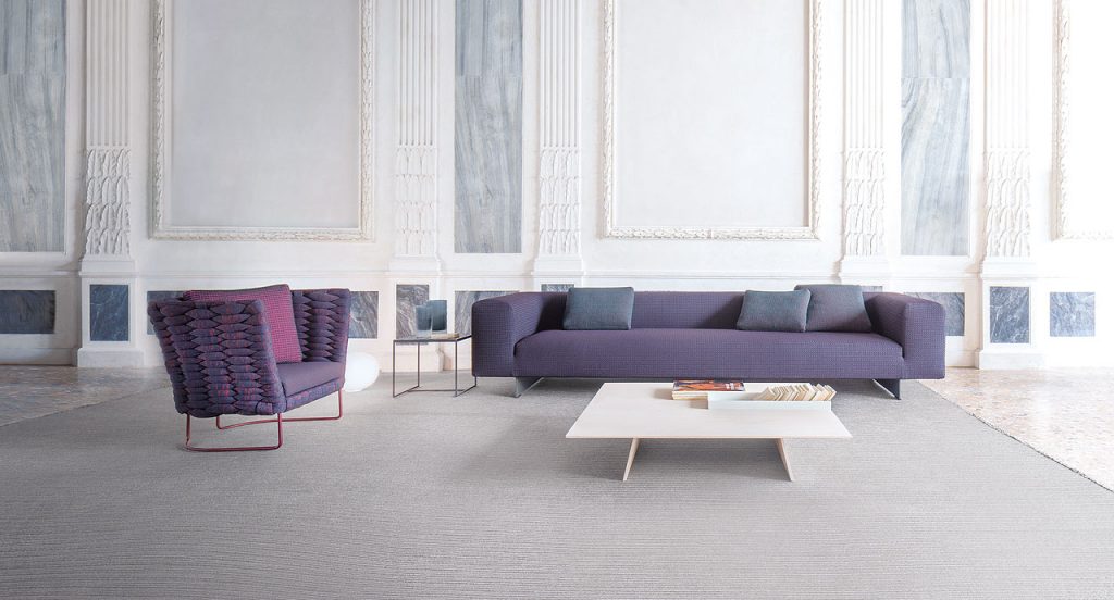 Samo rug made of grey rope cords and irregular shape in a living room.
