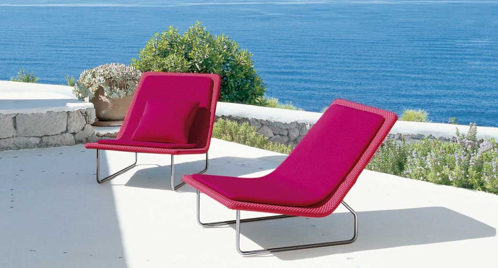 Two red Sand lounge chair with backrest, structure in steel , upholstery in rope fabric, cushion in polyester in the terrace.