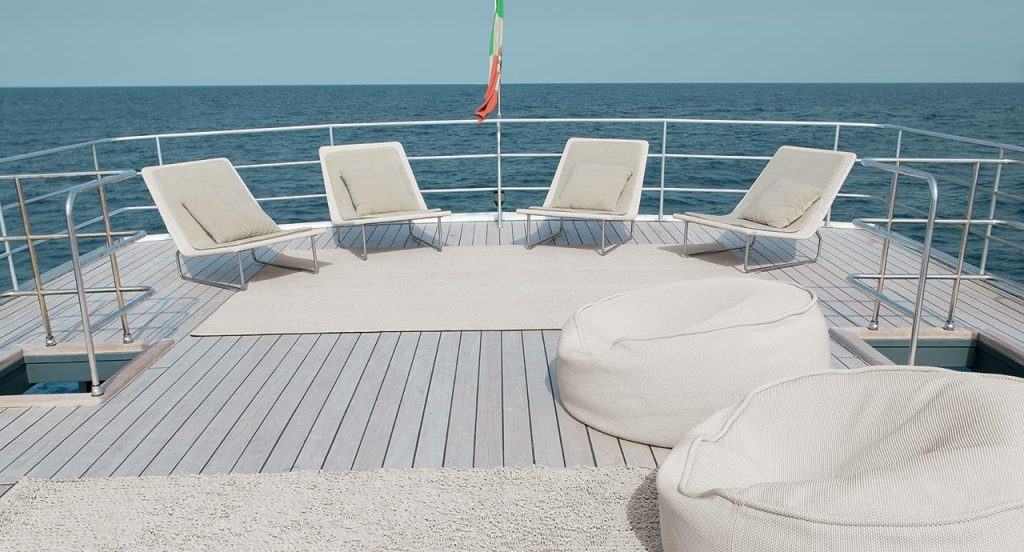 Four white Sand lounge chair with backrest, structure in steel , upholstery in rope fabric, cushion in polyester on a boat