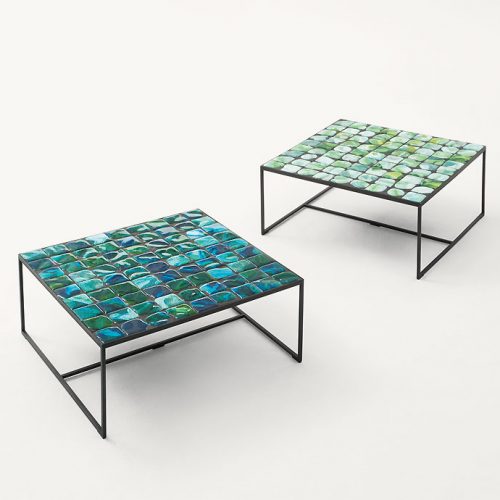 Two Sciara Side Tables, structure in black steel, top in lava stone, one in green and one in blue on a white background.