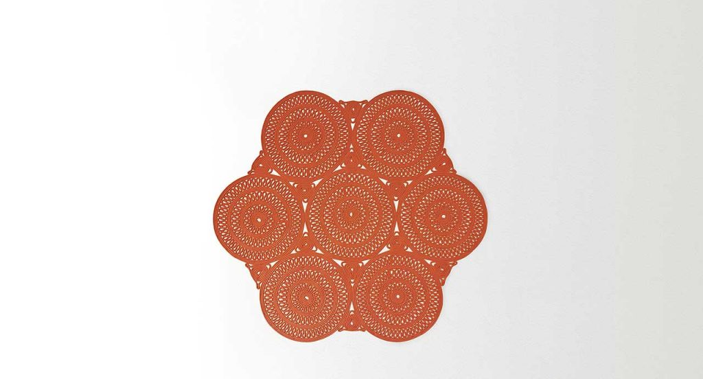 Shang Rug, round modules, orange cord in zig zag like pattern on a white background.
