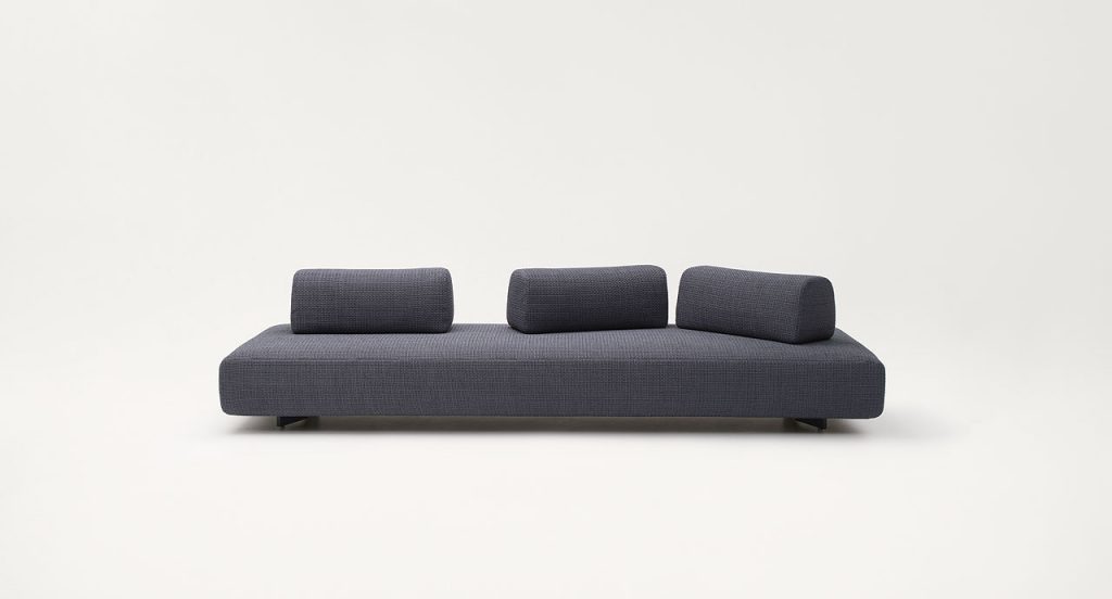 Orlando Indoor Sectional with backrest, upholstered in grey fabric on a white background.