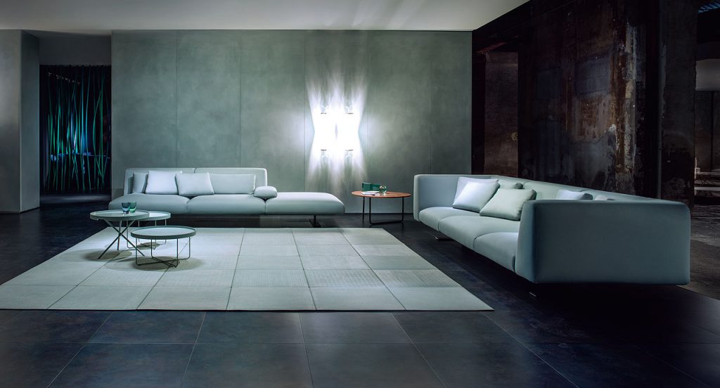 Two blue Passepartout side tables, aluminium round top, base in steel in a living room.