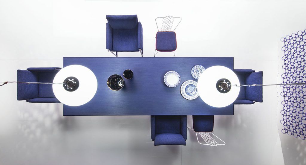 Portofino Indoor Dining Table, Structure and two legs in black steel, top in blue fibreboard in a dining room.