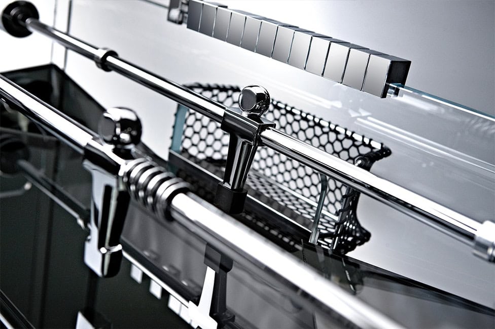 foosball bars made of shiny stainless steel on a white background