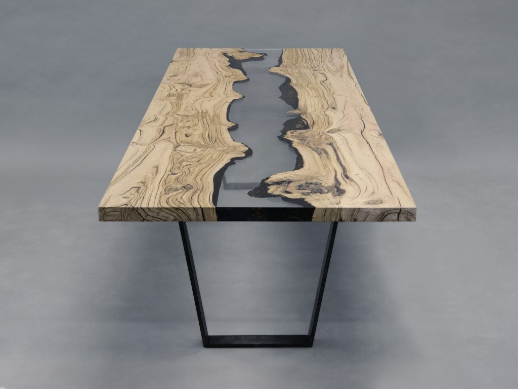 Creek Table with a rectangular shape, made of solid walnut wood with a natural finish and featuring a transparent resin inlay, set against a white background.