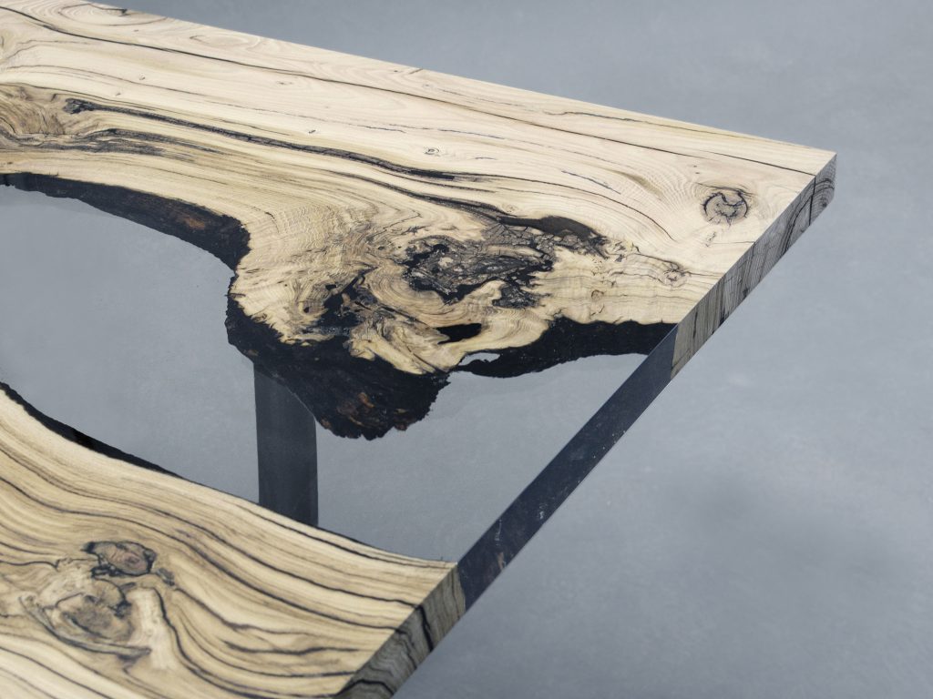 Creek Table with a rectangular shape, made of solid walnut wood with a natural finish and featuring a transparent resin inlay, set against a white background.