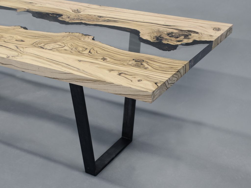 Creek Table with a rectangular shape, made of solid walnut wood with a natural finish and featuring a transparent resin inlay, set against a white background.