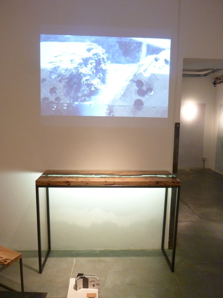 Canal Console with a rectangular shape, made of solid wood with a natural finish and featuring a transparent resin inlay, set against a white background.