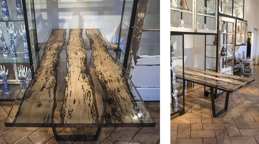 Chimenti Table with an elongated, organic shape, made of solid wood with a natural finish and featuring a transparent resin inlay, in a living room.