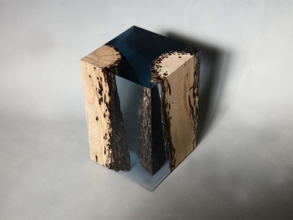 Anchor Twist Stool/Side Table with a cubic shape, made of solid wood and transparent resin inlays, on a white background.