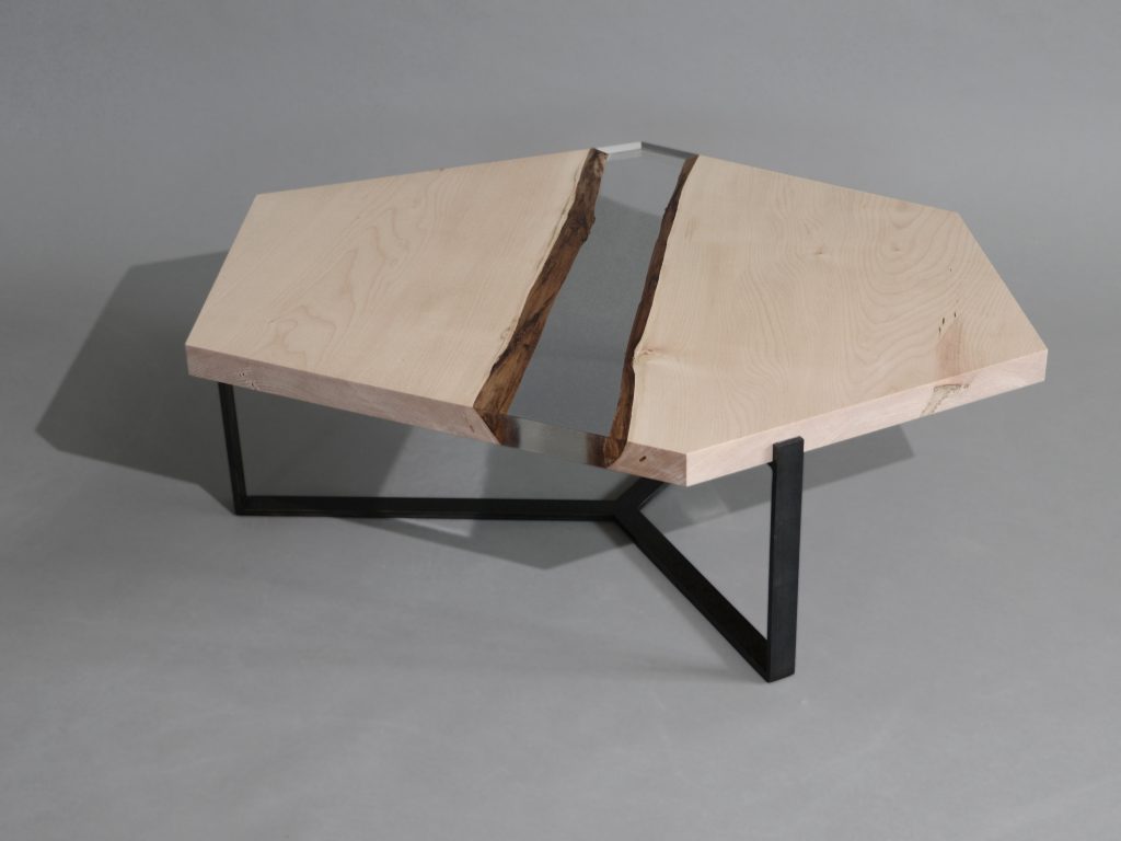 Crystal Maple Low Table with a polygonal shape, made of solid maple wood with a natural finish and featuring a transparent resin inlay, set against a white background.