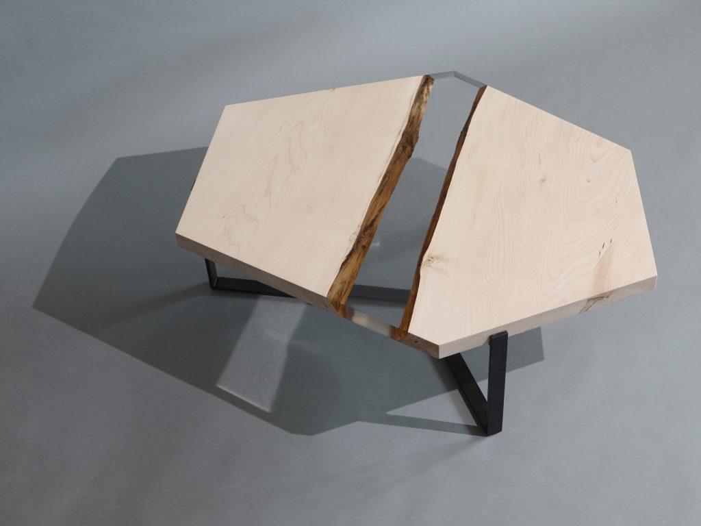 Crystal Maple Low Table with a polygonal shape, made of solid maple wood with a natural finish and featuring a transparent resin inlay, set against a white background.