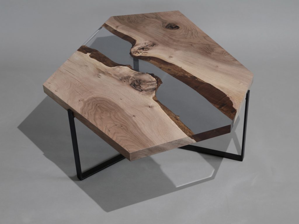 Crystal Walnut Low Table with a polygonal shape, made of solid walnut wood with a natural finish and featuring a transparent resin inlay, set against a white background.