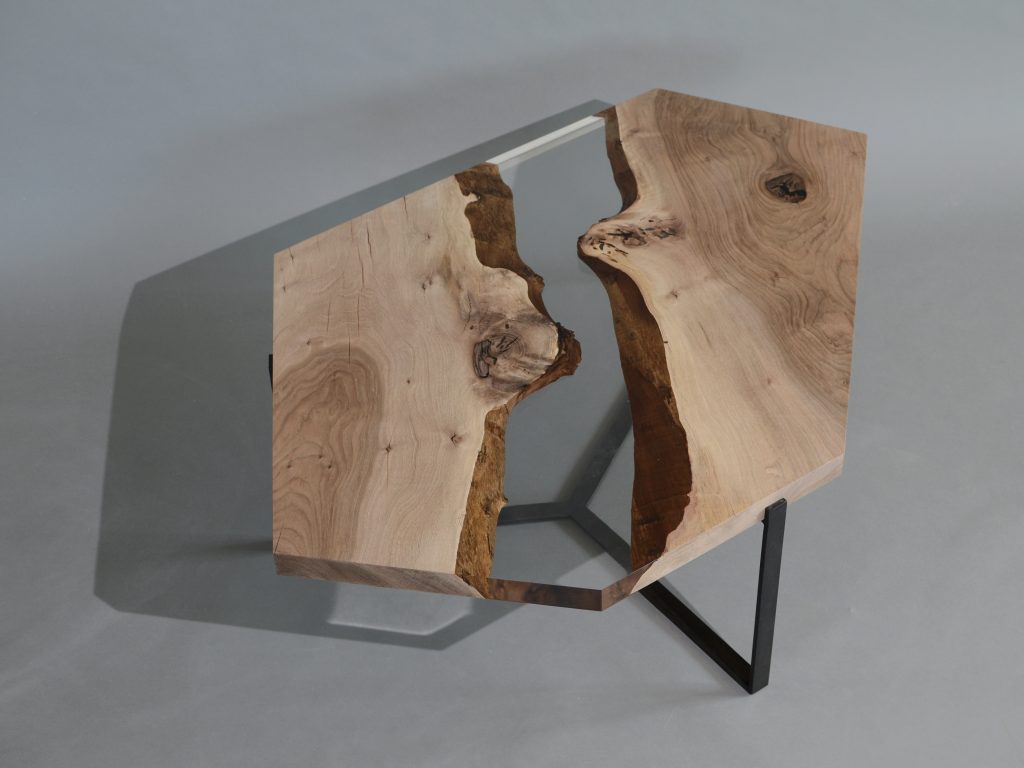 Crystal Walnut Low Table with a polygonal shape, made of solid walnut wood with a natural finish and featuring a transparent resin inlay, set against a white background.