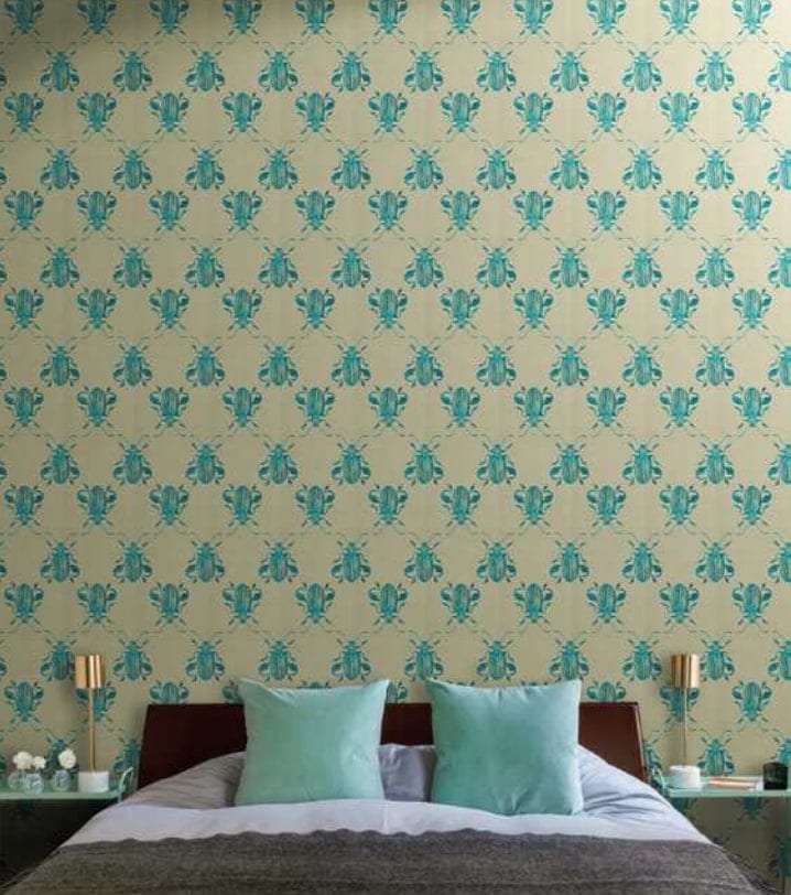 Scenery mosaic in yellow with green bugs pattern on a wall.