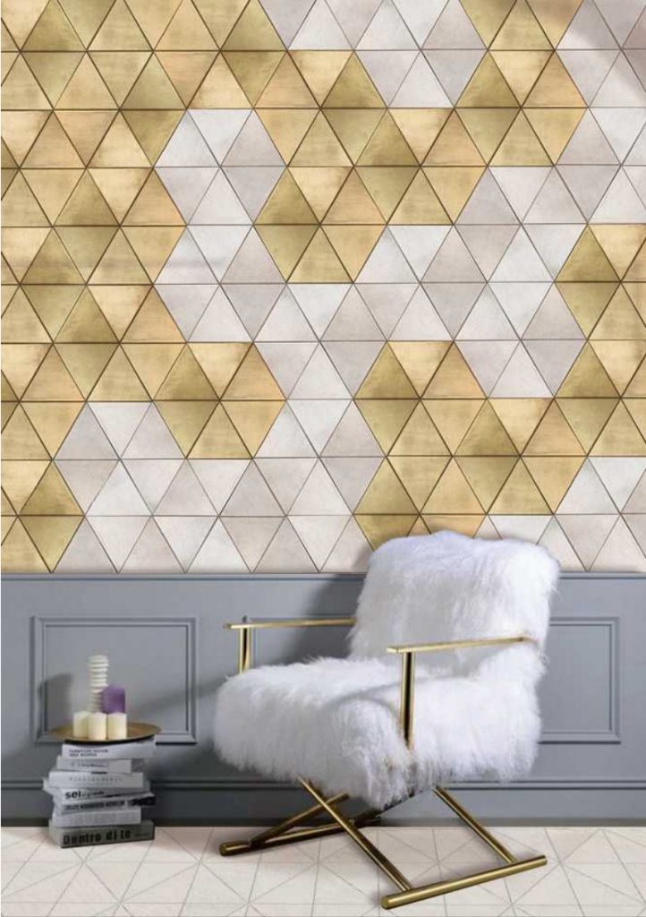 Trinity mosaic in yellow and white with a triangular pattern, set against a wall.
